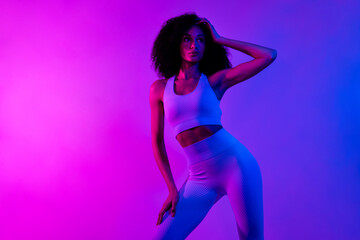 Obraz na płótnie Canvas Photo of focused gorgeous great shape fitness lady posing new sportswear ad isolated on pink blue light neon background