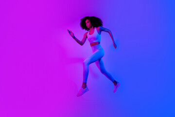 Fototapeta na wymiar Full size profile photo of beautiful slim girl jump rush empty space ad promo leggings top shoes isolated on neon ultraviolet color background