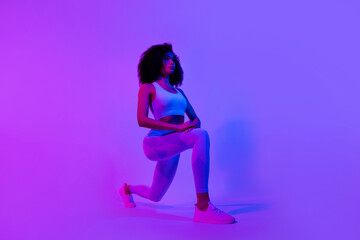 Obraz na płótnie Canvas Full body profile photo of motivated fitness trainer lady doing lunges stretch leg isolated on colorful neon light background