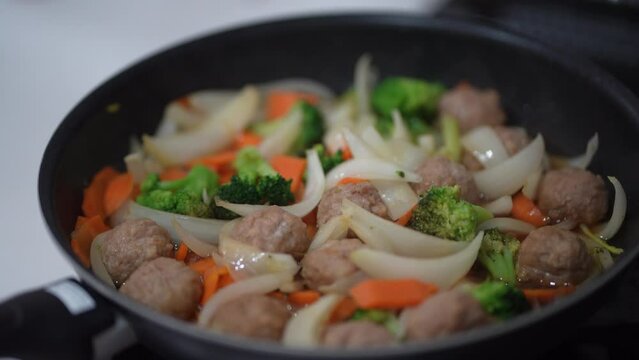 野菜と肉団子の甘酢あんかけを作る様子