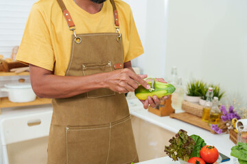Close-up male chef hand holding paring knife Use a knife to peel a large mango. Fast peeling with...