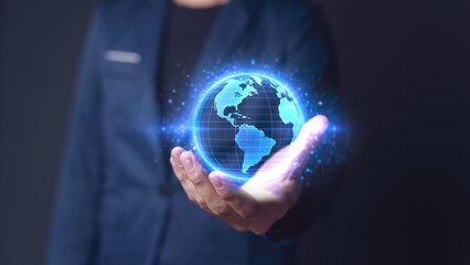 The businessman holds earth, symbolizing global connection of communication. The network of digital technology in future of information, business strategy innovation, marketing and finance worldwide.