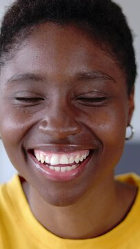 Close up portrait of young joyful african american woman smiling at camera on video call meeting from home. Happy people concept. Vertical video