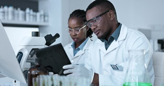 Science, tablet and team of black people in laboratory for information, innovation and planning. Man, woman and scientist collaboration on digital technology, medical data and biotechnology research