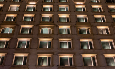 Hotel building side in the night with windows