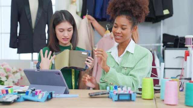 Sewing shop. Young female seamstress have an intimate video call with customers. Tailor or fashion designer. woman busy multi task work at home office studio on social media store.