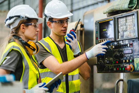 Testing new automation innovation tool for smart industrial, Professional robotic engineers specialist maintenance and control robot arm in factory warehouse, technician teamwork working together