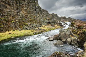 Beautiful landscape of Iceland. Landmark photo with an amazing waterfall from Thingvellir National Park of Iceland.