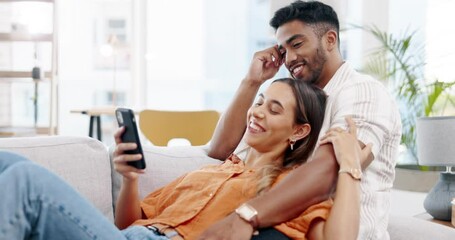 Couple, phone and relax on couch with social media app, blog or funny video on web in home. Man, woman and smartphone on sofa with conversation, reading and laughing with communication on internet