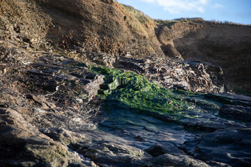 Surreal and beautiful cliffs at Perranporth Beach during low tide.