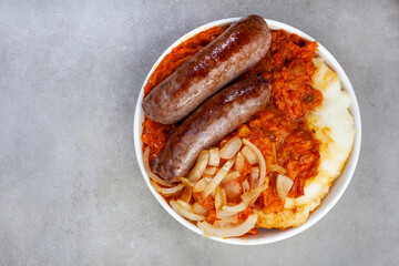 Traditional South African Pap and Wors, sausage with popular maize meal staple covered with...
