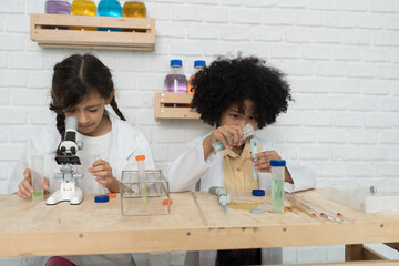 Group of child girl learning science and analyse liquid in the laboratory at school. Science and education, researcher and discovery concept