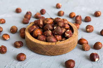 Wooden bowl full of hazelnuts on table background. Healthy eating concept. Super foods