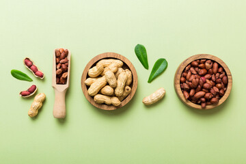 Fresh healthy peanuts in bowl on colored table background. Top view Healthy eating bertholletia concept. Super foods