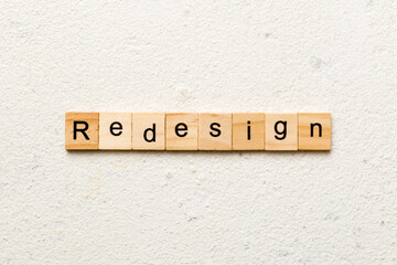 REDESIGN word made with wooden blocks concept
