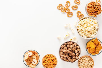 Bowls with different salty snacks for party. Fast food background