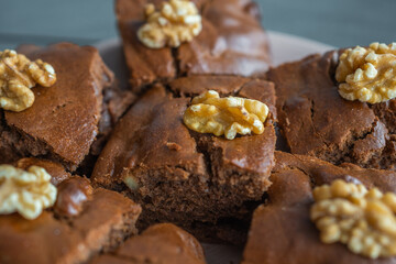 Oatmeal cake with bananas and walnuts on a dark grey background in home kitchen