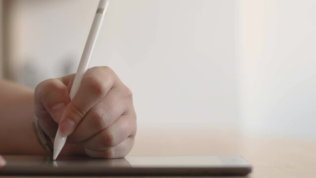 Hand use stylus writing on a tablet. concept of signature Electronic document signing via digital tablet, app design, Drawing structures, or creative with digital art