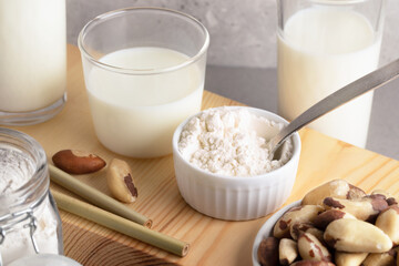 Vegan organic brazil nuts milk from nut powder. Alternative healthy lactose free milk. Top view.