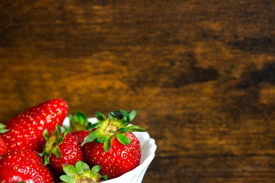 Fresh strawberries on a wooden background