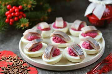 Chicken eggs stuffed with beets, curd cheese with herring and mayonnaise