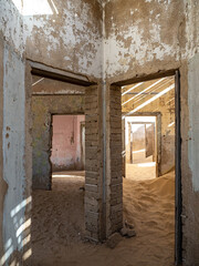 Fototapeta na wymiar Architectural views of sand filled abandoned homes in diamond mining ghost town.
