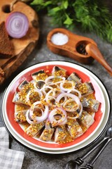 Pieces of herring in grain mustard with onion rings