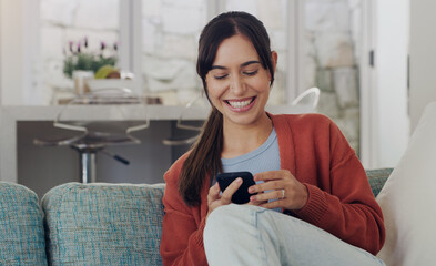 Happy, woman and typing on smartphone in living room, reading social media post and funny online meme. Female person, smile and relax with cellphone, download mobile games and web connection at home