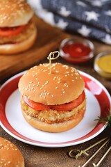 Homemade chicken burgers with tomato.