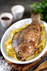 Baked crucian with potatoes and mayonnaise.