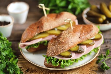 Healthy rye bun sandwiches with ham and pickled cucumbers.