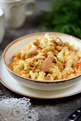 Braised rice with chicken fillet, chickpeas, onions, carrots and garlic.