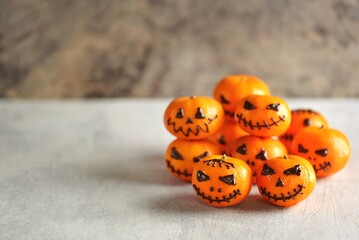 Jack-o-lantern pumpkins made from mandarin orange for children's Halloween party. Copy space. 
