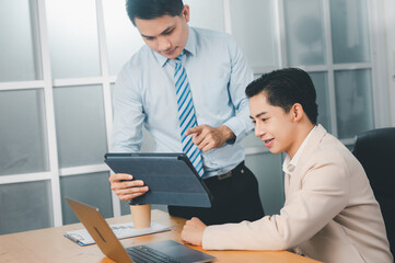 Fototapeta premium During work meetings in modern office, two business people explain statistics data to each other,Making reports, analitycs, and routine processing tasks. Concept of business