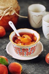 Homemade organic peach jam in a ceramic bowl.