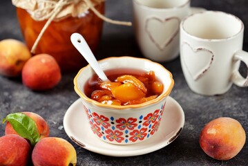 Homemade organic peach jam in a ceramic bowl.