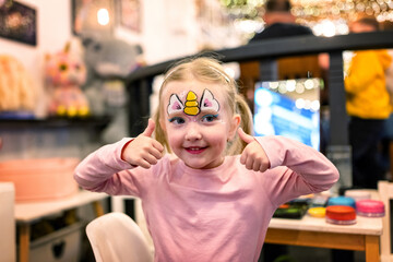 Happy little girl with  a painted face