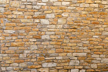 Old beige stone wall background 