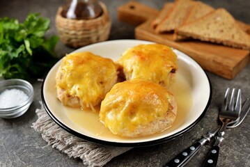 Chicken cutlets baked with cheese, mushrooms and potatoes