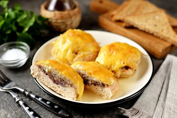 Chicken cutlets baked with cheese, mushrooms and potatoes