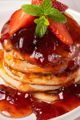 Mini pancakes with strawberry jam and strawberries