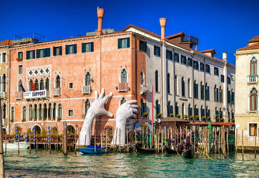 Sculpture SUPPORT and gondolas in Venice, Italy