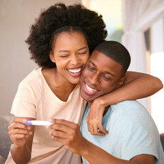 Fototapeta premium Excited Couple In Bedroom At Home Celebrating Positive Pregnancy Test Result