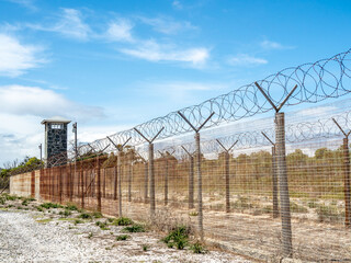 Double barbed wire fence at maximum security prison on Robben Island where Nelson Mandela and other prisoners were held. - obrazy, fototapety, plakaty