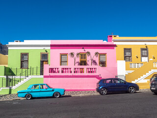 Colorful homes of Bo-Kaap in Capetown, South Africa, with deep blue sky in background.