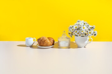 Summer kitchen still life. breakfast table setting . Summer background with croissants and daisies.	text space 