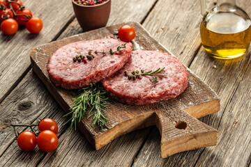 Fresh raw meat cutlets on a wooden background, banner, menu, recipe place for text, top view