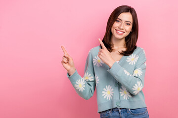 Photo of shiny pretty woman dressed teal outfit pointing two fingers empty space isolated pink color background