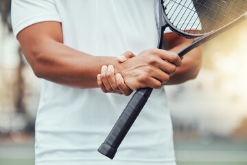 Tennis court, hand injury and man with racket for sports, fitness and match with discomfort or bruise. Joint pain, wrist and male player with arthritis, osteoporosis or fibromyalgia during training