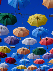 Fototapeta na wymiar Colorful and beautiful umbrellas hanging in the city street decoration